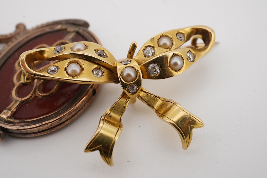 A yellow metal, seed pearl and diamond cluster seed ribbon bow brooch, width 36mm, gross weight 7.7 grams, together with a gilt metal and intaglio carnelian set spinning fob. Condition - poor to fair